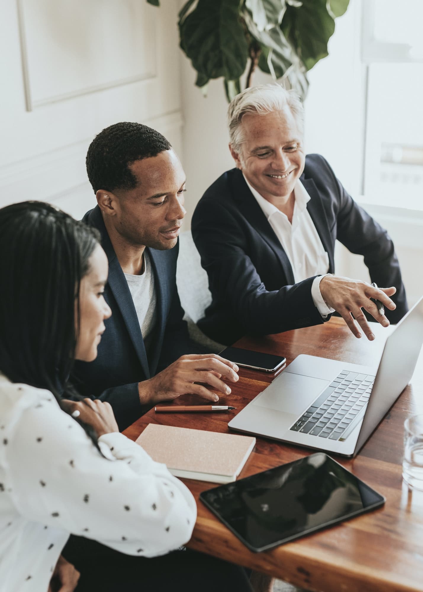 Happy business people using a laptop