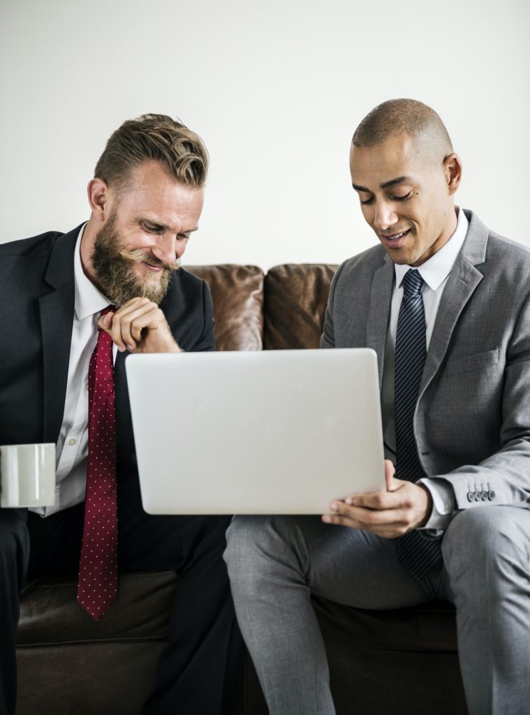 Two businessman sitting on a couch